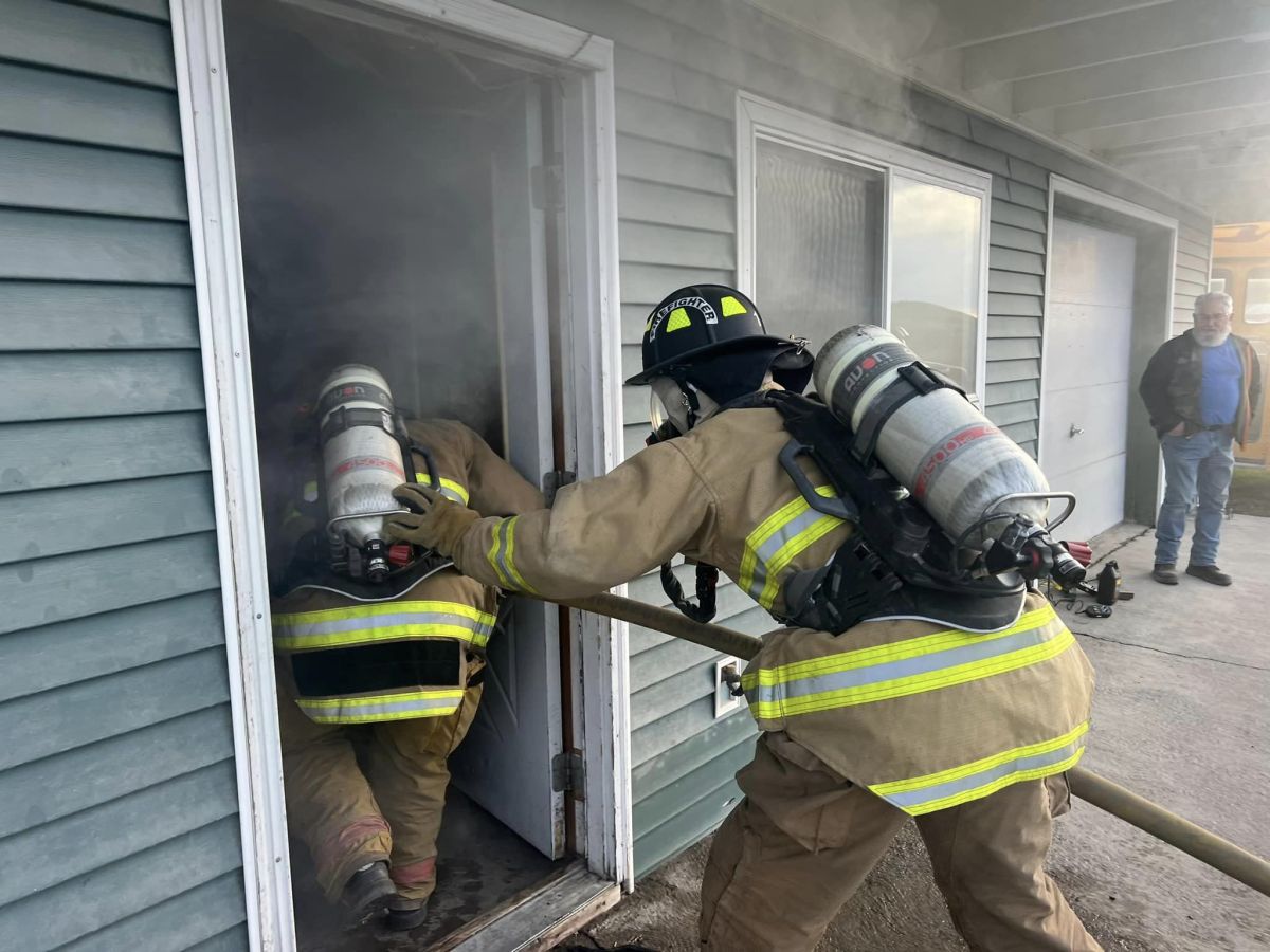 Fireman entering smoke filled house 