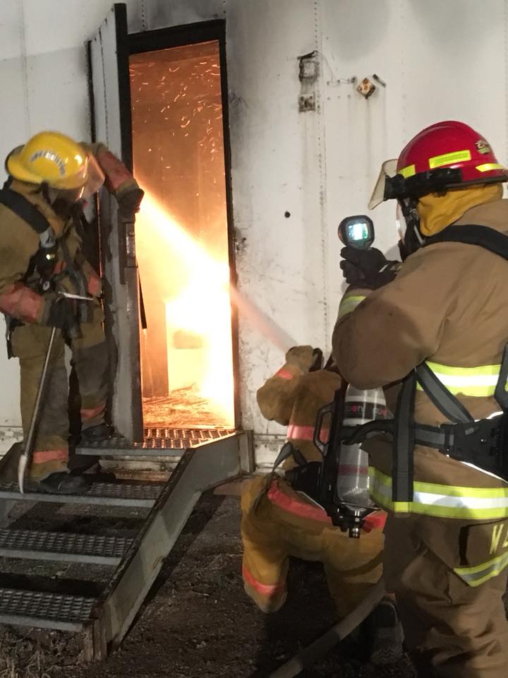 Firemen entering burning building 