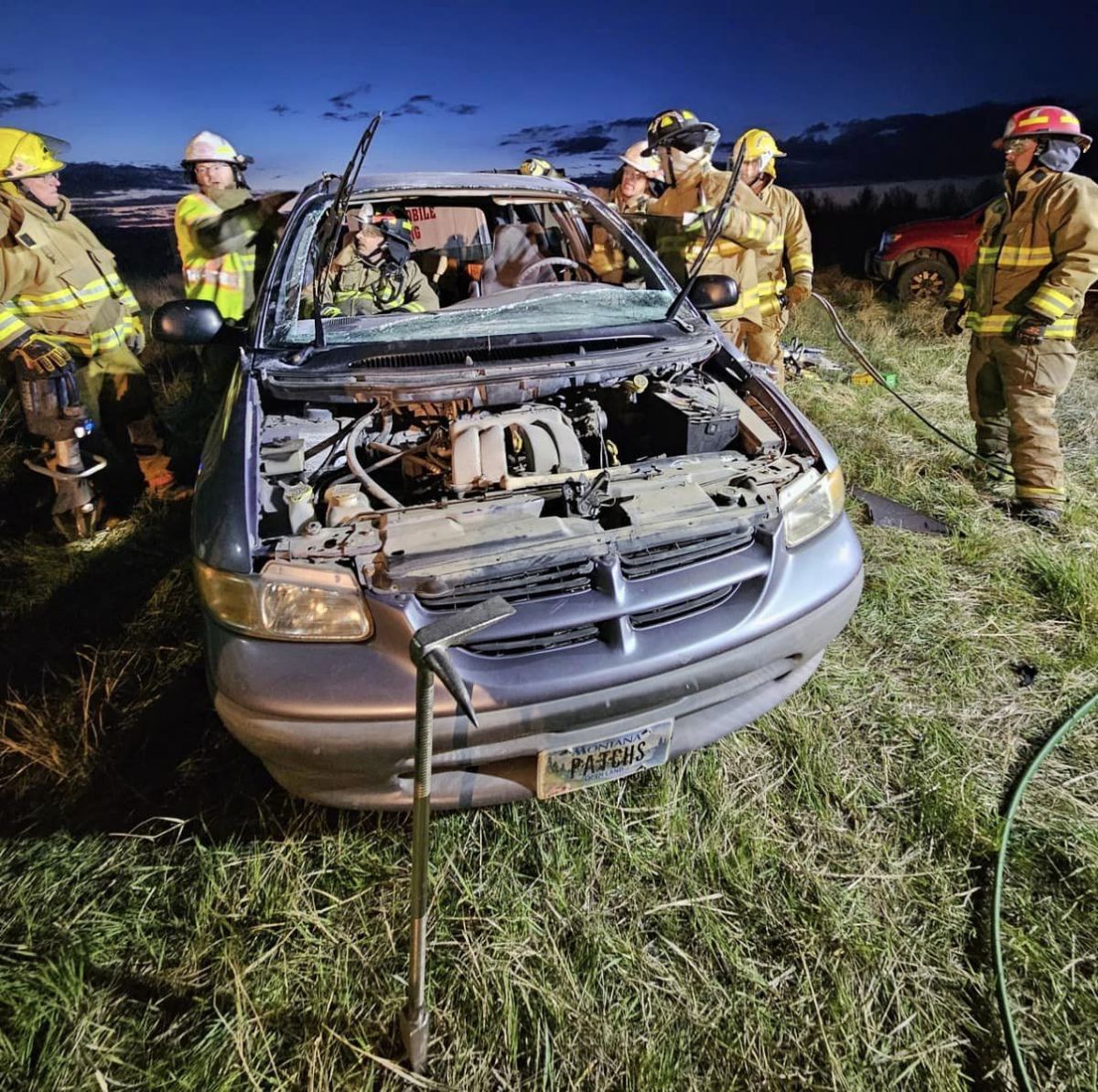 Firemen using jaws of life on vehicle